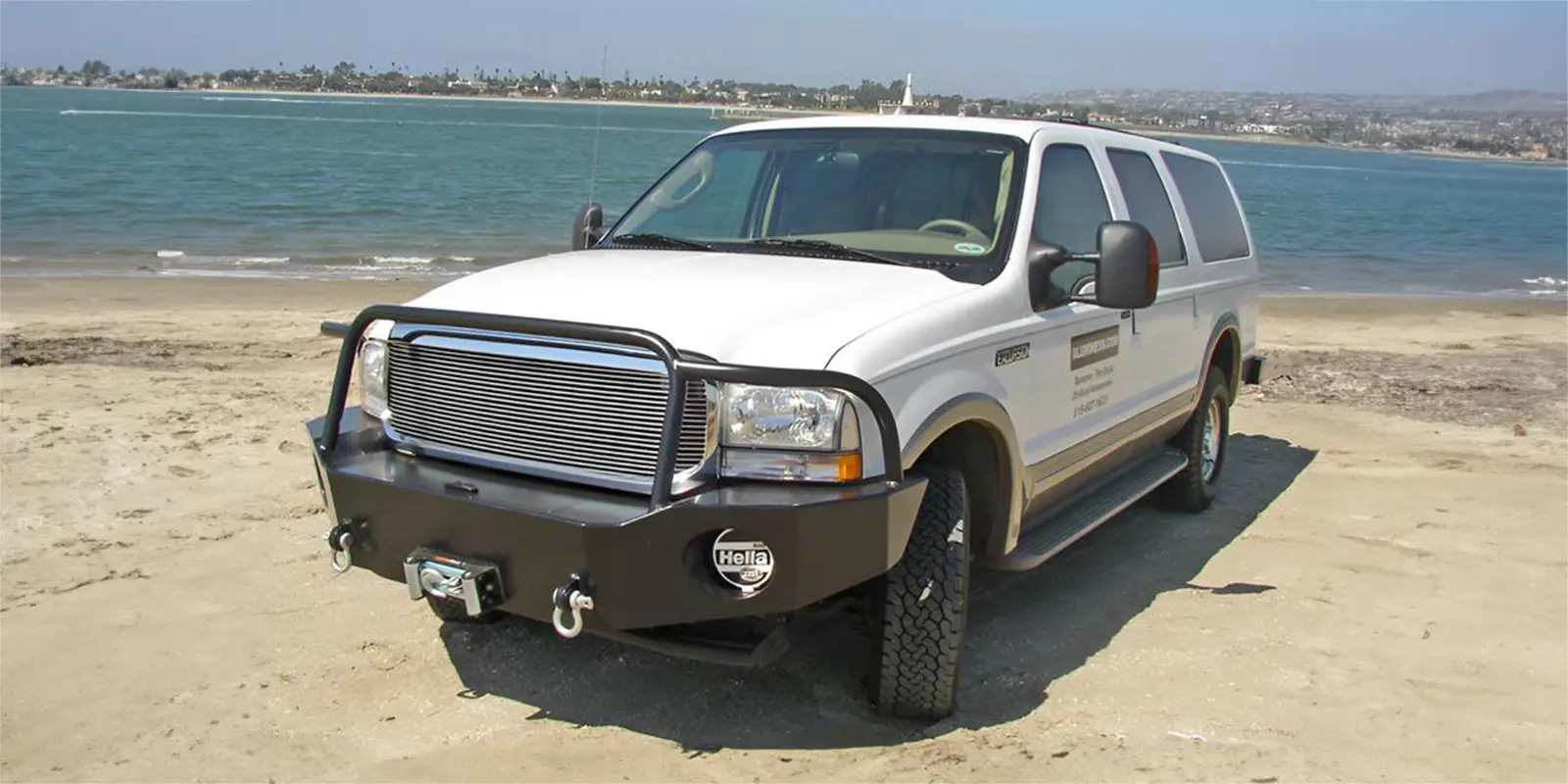 Ford Excursion van close to a lake.
